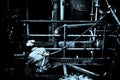 A chemical worker, seen from behind, is protected with a safety harness from fall monochromatic representation