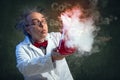 Chemist blowing in his experiment Royalty Free Stock Photo