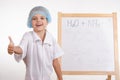 Chemist girl stands at the blackboard and shows class Royalty Free Stock Photo