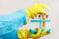 Chemist hands in rubber gloves is conducting chemical experiments in laboratory