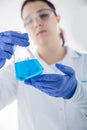 Chemist holding flask with blue liquid. Royalty Free Stock Photo