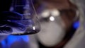 Chemist holding test tube with liquid, analyzing test result, biological weapons