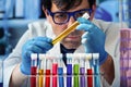 Chemist holding test tube of yellow liquid for analysis in the research lab Royalty Free Stock Photo