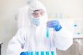 Chemist holding test tubes blue liquid for research and testing in laboratory,Covid-19,Coronavirus vaccine Royalty Free Stock Photo