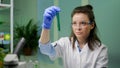 Chemist looking at test tube with geneticaly modified liquid