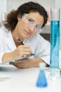 chemist looking at test-tubes with blue liquids Royalty Free Stock Photo