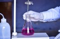 The chemist measures with precision in acid-base titration, adding solutions until neutralization