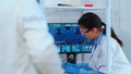 Chemist nurse working on computer in scientific laboratory