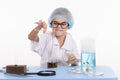 Chemist pours liquid from test tube into a flask