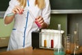 Chemist`s hands mixes the fluid from the test tubes Royalty Free Stock Photo