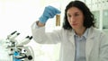 Chemist scientist holding test tubes with grains in laboratory closeup