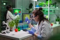 Chemist woman taking dna liquid from test tube with micropipette