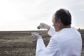 Chemist working in the field, comparing samples of different types of soil