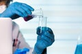 Chemist working in laboratory mixing fluids