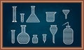 Chemistry equipment set on school chalkboard.