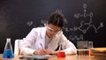 Chemistry experimenter writing down results of scientific researches in lab Royalty Free Stock Photo