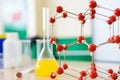 Chemistry glassware with liquid formula and molecular structure model at the science classroom laboratory. Royalty Free Stock Photo