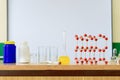 Chemistry glassware with liquid formula and molecular structure model at the science classroom. Royalty Free Stock Photo