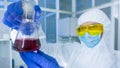 Chemistry lab - Researcher analyzing a liquid in laboratory flask