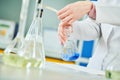 Chemical laboratory. Hand with flask during titrimetric analysis or titration Royalty Free Stock Photo