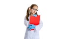 Studio shot of little cute girl, kid in white big gown as chemist, scientist doing experiment with colored chemical