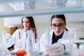 Young female researchers conducting laboratory test Royalty Free Stock Photo