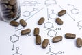 Chemistry reaction formula with brown pills Royalty Free Stock Photo