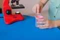 Chemistry. Science. Experiment. Education. Study. Smart boy working with microscope and test tubes. Little kid with test tubes.