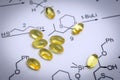 Chemistry science formula and oil capsules. Royalty Free Stock Photo