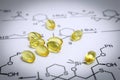 Chemistry science formula and oil capsules. Royalty Free Stock Photo
