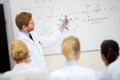 Chemistry teacher hold molecular model and teach students in classroom