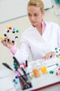 Chemistry teacher observing molecular structure in classroom Royalty Free Stock Photo