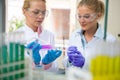 Chemists working with glassware in lab