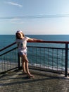 Chemitokvadzhe, Russia-June 13, 2019: teenage girl stands on the site of the Skywalk, on the background of the Black sea