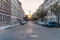 Chemnitz, a bulding crane behind a street with cars and houses at sunrise