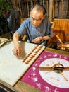 A candyman making traditional sugar candy on the Jinli Qintai ancient street of Chengdu at night in Sichuan China.