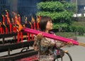 Chengdu, China: Woman Carrying Incense Sticks