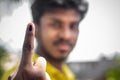 Chennai, India - 5th March 2021: Indian Voter Showing His Hand with voting sign and ink pointing vote for India