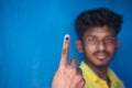 Chennai, India - 5th March 2021: Indian Voter Showing His Hand with voting sign and ink pointing vote for India