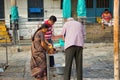 Chennai, South India - October 27, 2018: Hindu devotee performing prayer ritual with candles  diya  inside a hindu temple Royalty Free Stock Photo