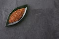 Red organic quinoa seeds in leaf shaped bowl - Chenopodium quinoa Royalty Free Stock Photo