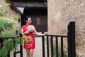 Asian Eastern oriental Chinese woman beauty in traditional ancient dress costume red cheongsam in ancient town old culture fashion Royalty Free Stock Photo
