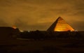 The Cheops pyramid from Giza at night. Giza pyramid illuminated at night seen from the roof of a hotel. Pyramid of Khufu Royalty Free Stock Photo