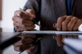 Business man in suit, hand write and signs checkbook. Paycheck and payroll concept.