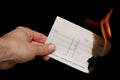 Cheque being burnt cutout Royalty Free Stock Photo