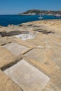 Chequerboard of rock-cut saltpans on the shoreline in Malta, Gozo Royalty Free Stock Photo