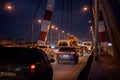 A large automobile bridge on which cars drive at night. Royalty Free Stock Photo