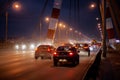 A large automobile bridge on which cars drive at night. Royalty Free Stock Photo