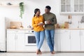 Cherful Young Black Couple Drinking Morning Coffee Together In Kitchen