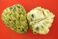 Cherimoya cut open on orange